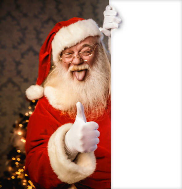 istock Santa Claus pointing on blank banner 1420852115