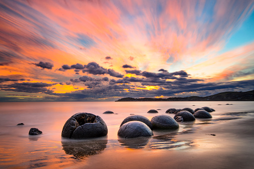 A indyllic beach at sunset and reflection on the water. Loredo beach in Cantabria, Spain