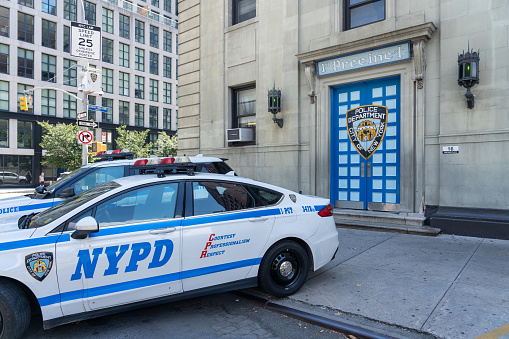 New York City, NY, USA - August 20, 2022: Two Police cars at the 1st Precinct Police Station in New York City, USA, serve an area that consists of a square mile on the southernmost tip of Manhattan.