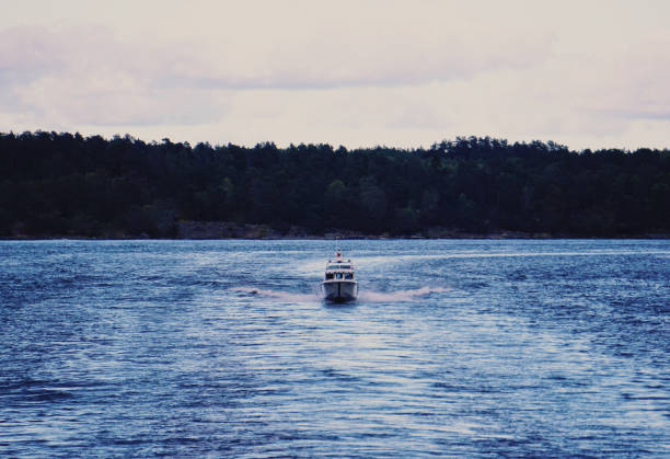 Evening landscape with two fishermen and a boat. Color film, creative monocle lens.