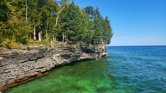 Cave Point Country Park at Door County in Wisconsin, clear green water of lake Michigan background