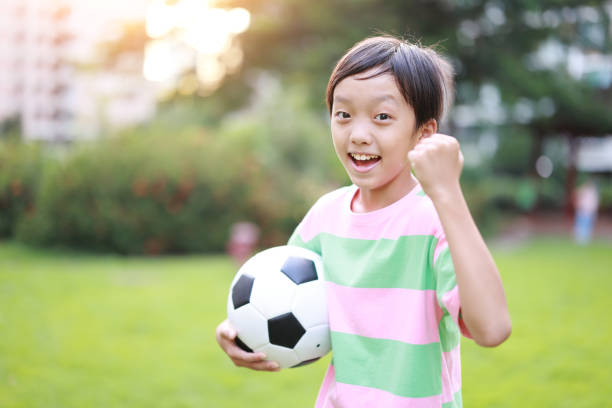 istock Boy with soccer ball 1420872228