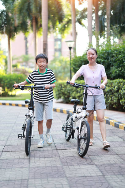 istock Mother teaching son to ride a bicycle 1420872301