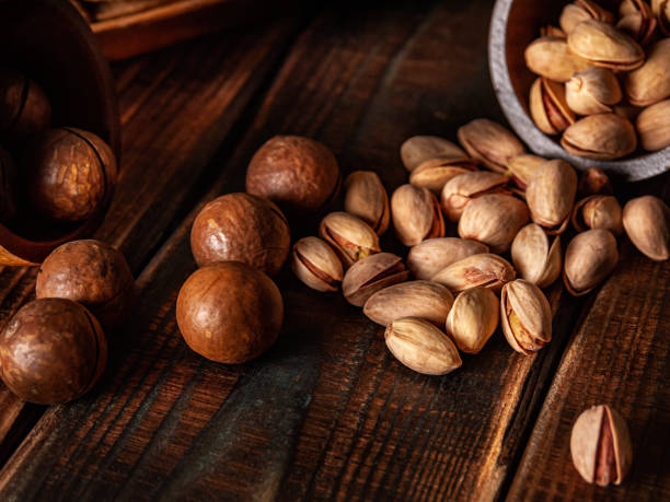 istock Macadamia nuts and pistachios in low key 1420872730