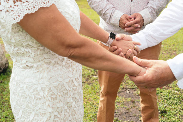 istock Bride and groom holding hands at wedding 1420872880