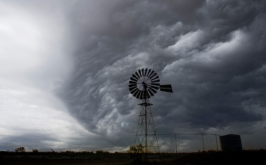 Storm clouds in the outback with windmill.