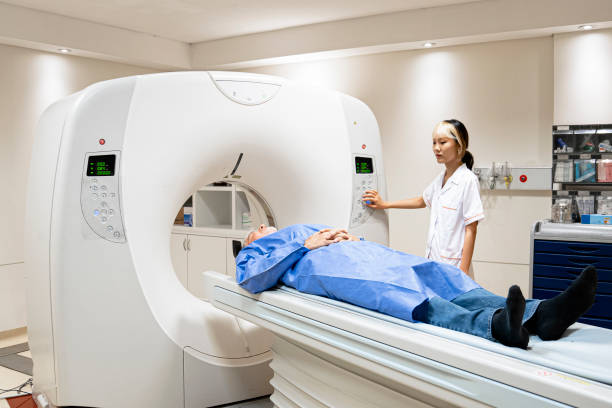 istock Patient going through an MRI scanner operated by young female technician 1420879551