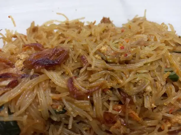 Photo of Vermicelli fried or called bihun goreng served in a plastic box with top view photo