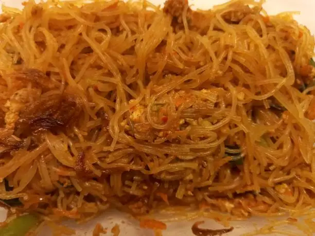 Photo of Vermicelli fried or called bihun goreng served in a plastic box with top view photo