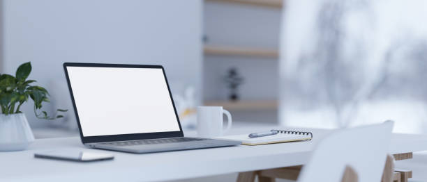 istock Modern home workspace with laptop mockup and stuff on white table. 1420883080