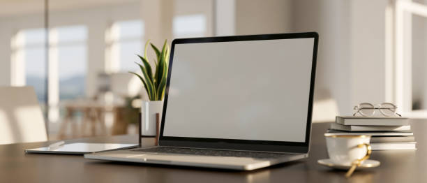 istock Laptop mockup, coffee cup, book, tablet and decor plant on modern tabletop. workspace close-up 1420883398