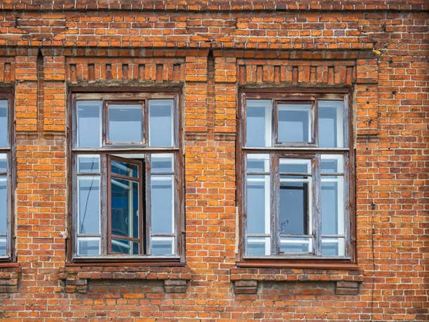 istock Two windows of the old mansion 19 century with brown bricks wall 1420884951