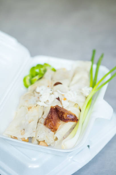 istock Thai fresh spring rolls called Por Pia Sod in Thai, stuffing with fresh vegetable, sprouts, vegetables wrapped with rice paper topping with  crab meat and fresh chili served with special gravy 1420888781