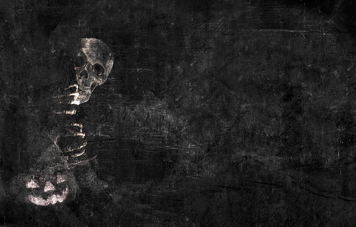 A skeleton peeks out from behind a tree against a black grunge background.