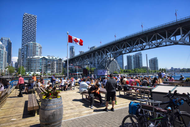 док на острове гранвиль в день канады, ванкувер, канада - false creek стоковые фото и изображения