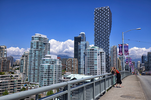 July 1, 2022, Young woman enjoying the view of False Creek on Granville Bridge on Canada Day, Vancouver, Canada