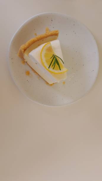istock Lemon Tart citrus cake in white dish and white cloth background, cake and bakery concept 1420897380