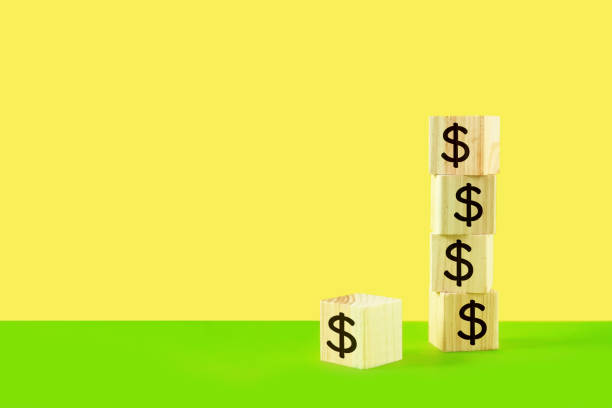 istock The blocks with dollar signs are stacked vertically in a row. 1420897695