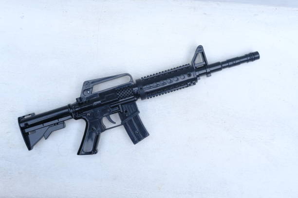 istock black plastic toy gun with white background 1420906759