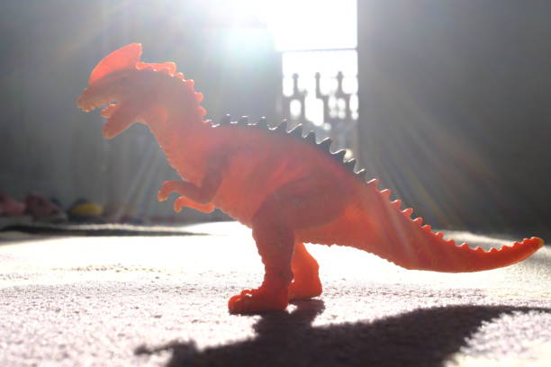 istock dinosaur toy on the carpet and its shadow 1420907019