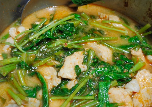 Thai Cuisine and Food, Cooking Thai Spicy Red Curry with Water Spinach, Chicken and Coconut Milk.