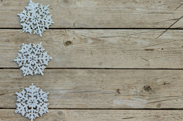 istock Christmas decorative silvery snowfields on a rustic wooden background. Waiting for the holiday, a place for the text. 1420909347