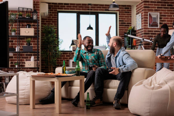 istock Multiethnic team of people doing highfive gesture after winning video games 1420910216