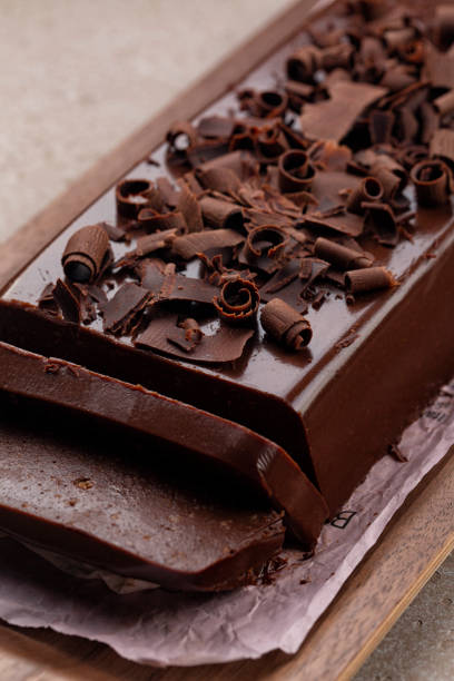 istock Dark chocolate curls on Mousse Jiggly or Chocolate Pudding Cake, made with gelatin and Amaretti, no bake dessert. Vertical image. 1420910291