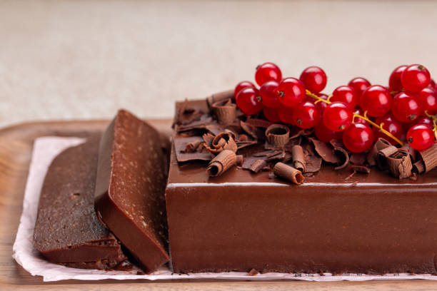 istock Sliced Chocolate Pudding Cake, Mousse Jiggly made with gelatin and Amaretti, no bake dessert, decorated with red currant. Close-up. 1420910317