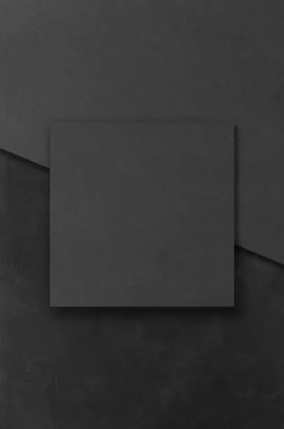 Photo of Black rectangular mockups on a dark concrete background. Design elements or portfolio. Copy space.