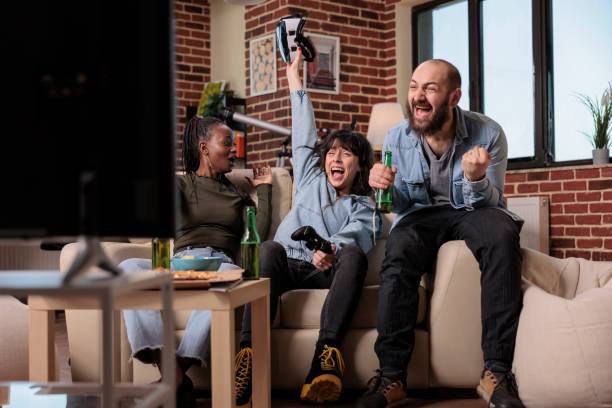 istock Multiethnic group of people celebrating video games victory 1420910526