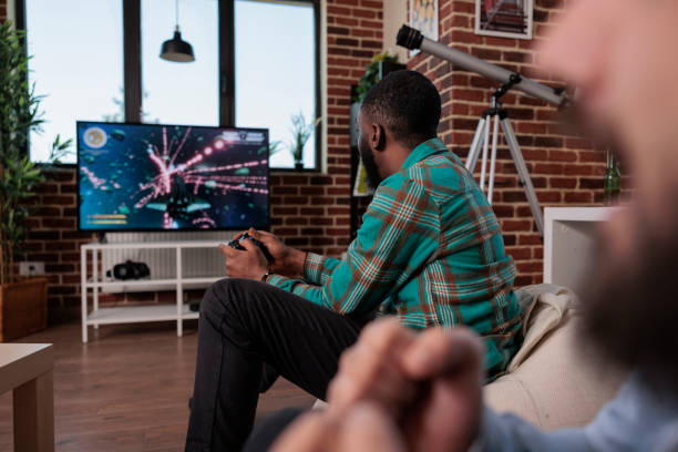 istock African american man holding console controller to play video games 1420910943