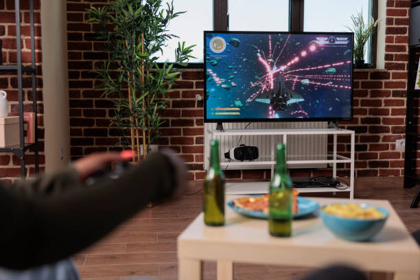 istock Young woman having fun with shooting video games on console 1420910993