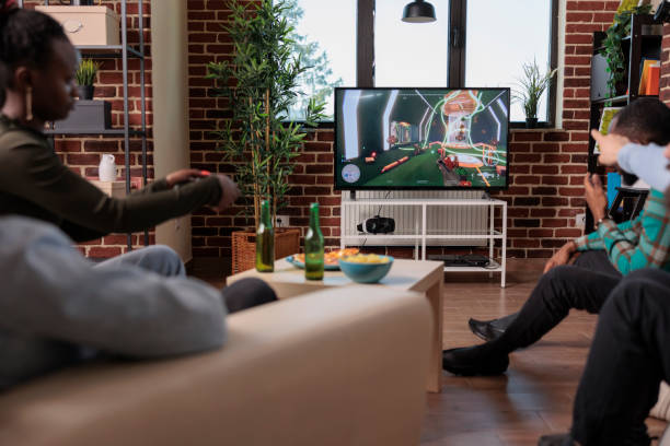 istock Diverse people playing video games competition on tv 1420911162