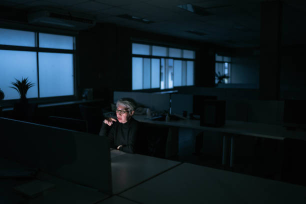 istock Asian senior woman struggles to stay awake while working late. 1420912059