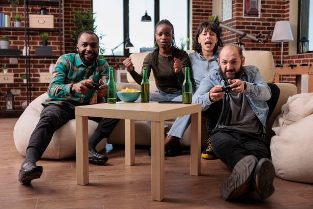 istock Happy friends laughing while they play strategy video games 1420912103