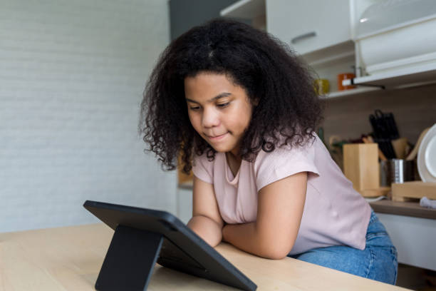istock Girl using tablet and social media. Child playing on her digital tablet 1420913141