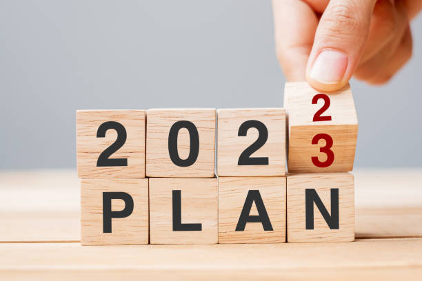 istock hand flipping block 2022 to 2023 PLAN text on table. Resolution, strategy, goal, motivation, reboot, business and New Year holiday concepts 1420915370