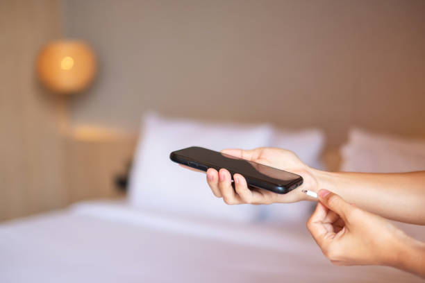 istock Hand Charging battery on mobile smartphone. Technology, multiple sharing and recharge concepts 1420916424