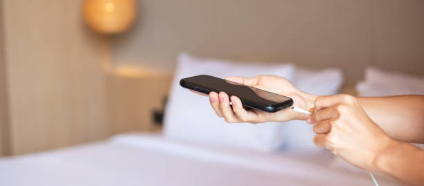 istock Hand Charging battery on mobile smartphone. Technology, multiple sharing and recharge concepts 1420916452