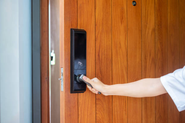 istock man holding handle of smart digital door lock while open or close the door. Technology, electrical and lifestyle concepts 1420916693