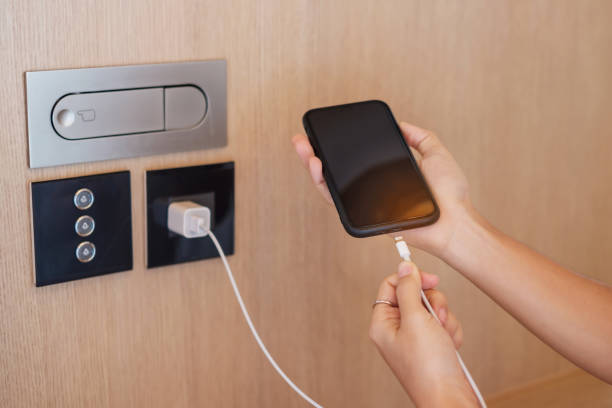 istock Hand Charging battery on mobile smartphone. Technology, multiple sharing and recharge concepts 1420916733