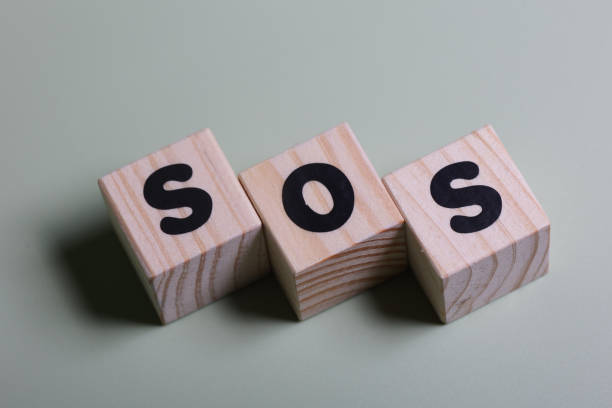 istock SOS word on wooden block  on green background 1420918558
