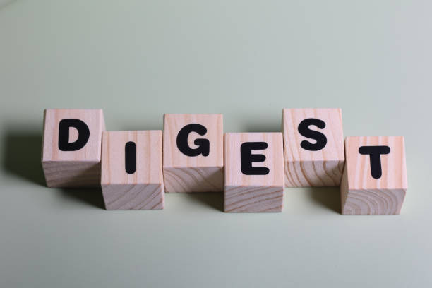 istock Digest word on wooden block  on green background 1420919190