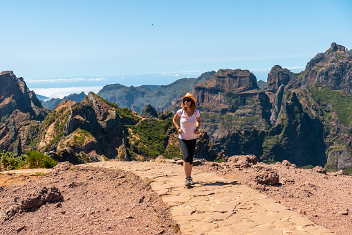 A tourist walking on the trekking trail at Pico do Arieiro, Madeira. Portugal