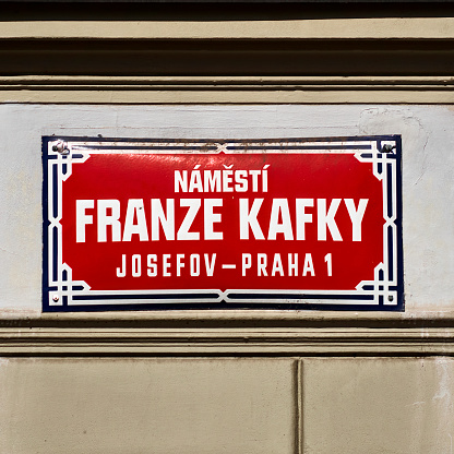 Prague, Czechia, August 29, 2022: Street sign of Franz Kafka street in Prague, red sign with white writing