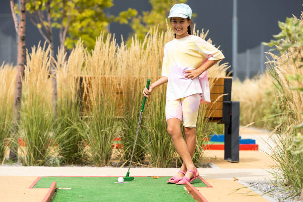 istock Beautiful little girl playing mini Golf 1420924078