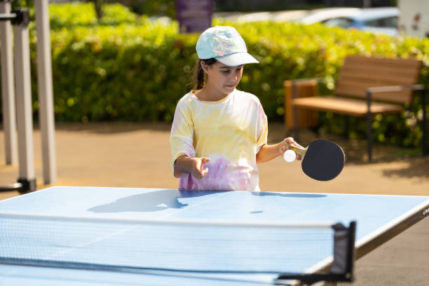 istock Little girl playing ping pong in park. 1420924343