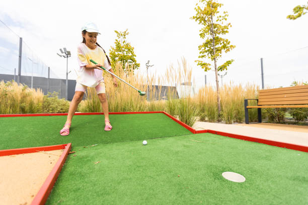 istock Beautiful little girl playing mini Golf 1420924378