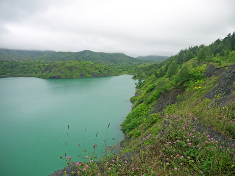 Turquoise Lake with bright blue-green water, famous Sakhalin travel destination, former germanium coal mine